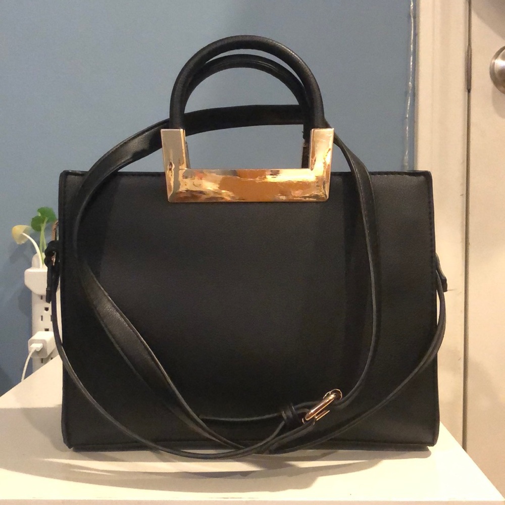Small black crossbody bag with gold accents